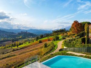 a villa with a swimming pool in the hills at Spacious apartment with infinity pool in Poppi
