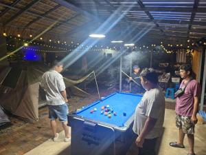 a group of people standing around a pool table at Chaba4 in Ban Nong Bua Noi