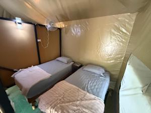 a room with two beds in a tent at KRITAJNA SAFARi LODGE in Dominical