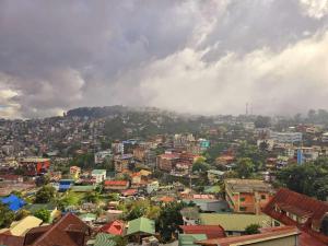 a view of a city with buildings on a hill at Zhongkebole Suites in Baguio