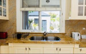 a sink in a kitchen with a window at ABC Beachside Retreat in Rosebud +37 photos
