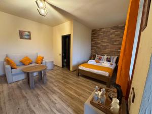 a hotel room with a bed and a couch at Moon Valley Guest House in Margahovit