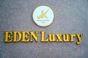 a sign for a edmonton luxury hotel with a gold sign at Eden Luxury Hotel in Thái Bình