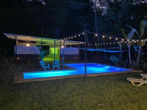 a swimming pool at night with a tent and lights at KRITAJNA SAFARi LODGE in Dominical