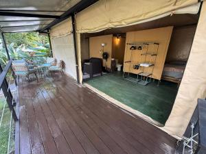 an inside view of a tent with a wooden deck at KRITAJNA SAFARi LODGE in Dominical +24 photos