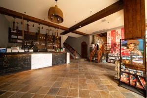 a restaurant with a counter and a bar in a room at YangShuo Coco Garden Villa-Western food&English Guide in Yangshuo