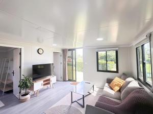 a living room with a couch and a tv at Alpaca Haven Farm in Rotorua
