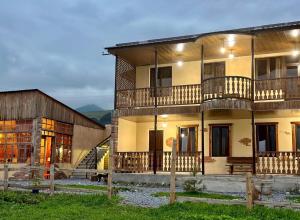 a building with two balconies on the side of it at Moon Valley Guest House in Margahovit