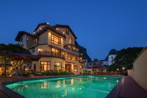 a villa with a swimming pool at night at YangShuo Coco Garden Villa-Western food&English Guide in Yangshuo