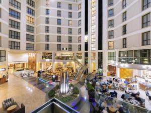 an empty lobby of a hotel with people sitting at Sofitel London Gatwick in Horley