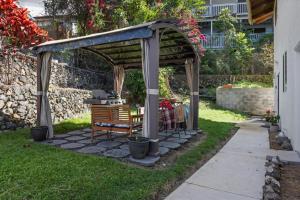 a gazebo with a bench in a yard at Quiet 2BR Kona Retreat Beach Gear BBQ Patio in Kailua-Kona