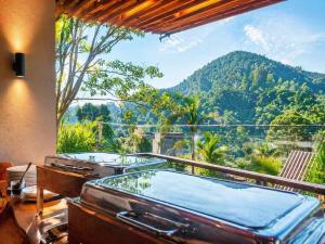 a bath tub in a room with a view of a mountain at Monaara Leisure - Ella in Ella