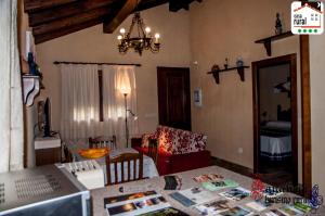 a living room with a couch and a table at Casa Rural "La Noria" in El Puente