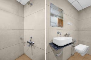 a bathroom with a sink and a shower and a toilet at Super Hotel O Navasari Bus Terminal Formerly Jay Shankar in Sisodra