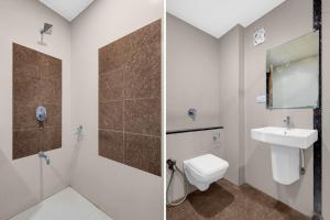 a bathroom with a toilet and a sink at Super Hotel O Navasari Bus Terminal Formerly Jay Shankar in Sisodra +38 photos