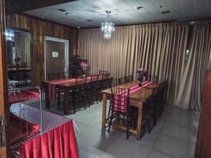 a dining room with tables and chairs and curtains at HOTELINDA Suites in Vigan
