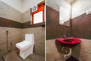 a bathroom with a toilet and a red sink at Super Hotel O CSIR Pappanamcode Formerly Ambadi Guest House in Poojapura +32 photos