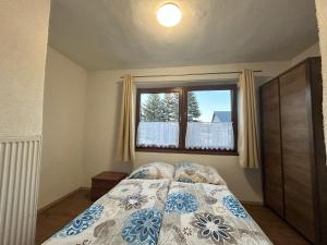 a bedroom with a bed and a window at Privát Tatry Štrba Vysoké Tatry in Štrba