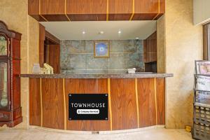 a restaurant with a counter with a townhouse sign on it at Townhouse Vadodara Railway Station Road Formerly Hotel Raajpath in Vadodara