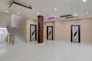 a hallway with three doors and a staircase in a building at Hotel O Tarapith Temple Formerly Prerana 2 in Tarapith