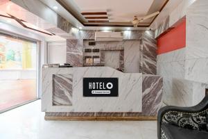 a lobby with a hotel sign on a marble wall at Hotel O Tarapith Temple Formerly Prerana 2 in Tarapith