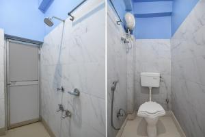 a bathroom with a shower and a toilet at Hotel O Tarapith Temple Formerly Prerana 2 in Tarapith