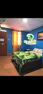 a bedroom with a bed with a football sign on the wall at EL BOSQUE Hostal in Chiclayo