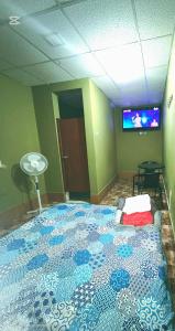 a bedroom with a large bed in a room at EL BOSQUE Hostal in Chiclayo