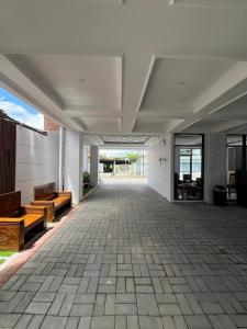 an empty hallway of a building with benches at Pangeran Residence 2 in Adi Sutjipto