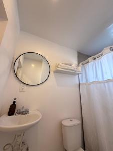 a bathroom with a sink and a mirror and a toilet at RA Suites in Tijuana +41 photos