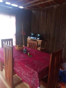 a dining room table with a red table cloth on it at Maison typique Madagascar in Anjiabe