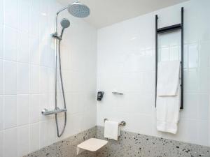 a bathroom with a shower with a sink and a toilet at Ibis Styles Dakar in Dakar +52 photos