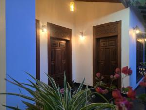 a pair of doors in a building with plants at Udara Guest - Yala Safari in Yala +30 photos