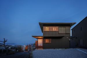 a house with a garage on a street at 民泊-天- in Beppu