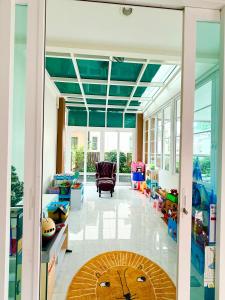 a living room with a large glass door with a lion rug at Bluesky Villa Bang Sare in Bang Sare