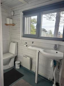a bathroom with a sink and a toilet and a window at Rörvik Stugor in Geta +162 photos
