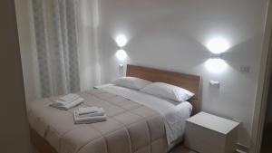 a bedroom with a bed with two towels on it at La Cilinella del Salento in Copertino