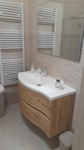 a bathroom with a sink and a mirror and a toilet at La Cilinella del Salento in Copertino