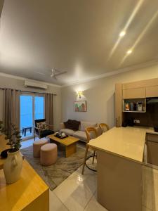 a living room with a couch and a table at Central Park, The Rooms 1 & 2 BHK Poolview Suites in Gurgaon