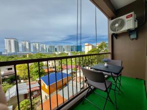a balcony with a table and chairs and a view at Suite Escape Mactan , condo with balcony near Mactan Newtown and Mactan Airport in Mactan