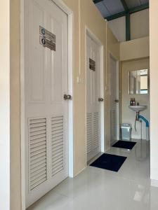 a hallway with two white doors and a sink at TUK&TOON House in Sathani Ban Thap Chang +47 photos