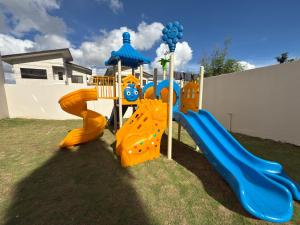 a playground in a yard with a slide at Suite Escape Mactan , condo with balcony near Mactan Newtown and Mactan Airport in Mactan