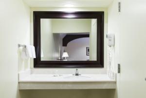 a bathroom with a sink and a mirror at Super 8 by Wyndham Fairfield Tx in Fairfield +17 photos