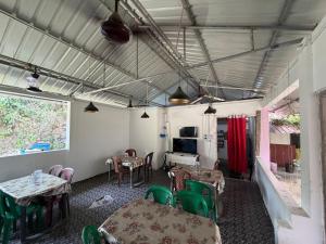 a dining room with tables and chairs and a window at Harmony - Havelock Island in Havelock Island
