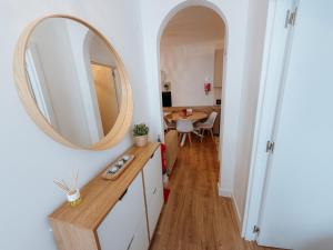 a bathroom with a mirror on the wall and a table at Sol e Rio in Setúbal +30 photos