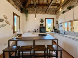 a kitchen with a large island with stools at Villa Venezia Apartment in Dolo