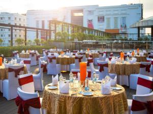 a group of tables and chairs on a roof at Novotel Kolkata Hotel and Residences in Kolkata +243 photos