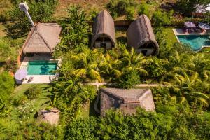 an aerial view of a resort with a swimming pool at Rhipidura Bungalows by Phocéa in Pemuteran