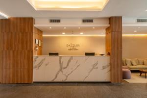 a lobby of a hotel with a reception desk at Dazzler by Wyndham Puerto Madryn in Puerto Madryn