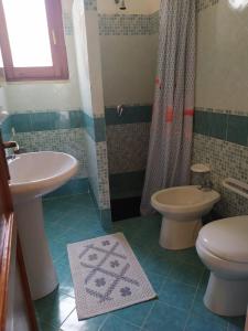 a bathroom with a sink and a toilet and a shower at Tra mare e relax in Favignana
